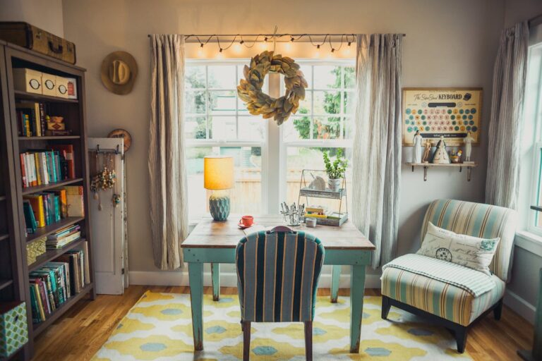 A bright and cozy home office with vintage decor, bookshelves, and natural light.