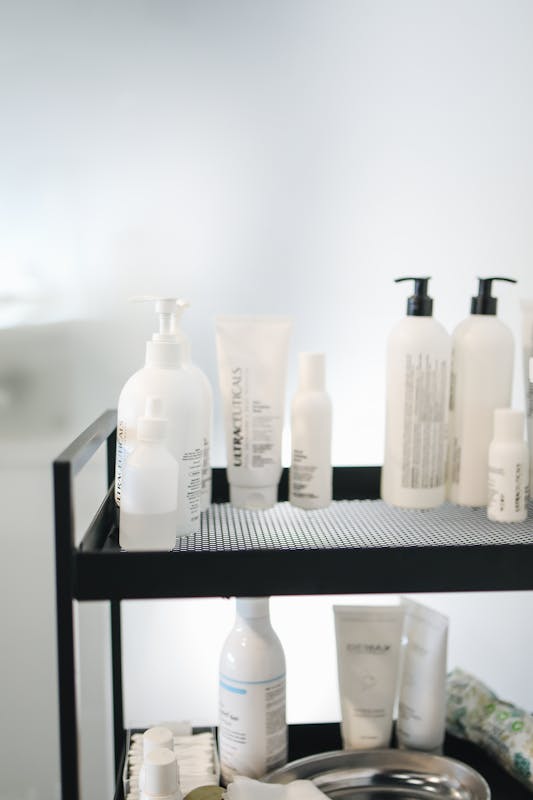 Aesthetic display of skincare products arranged on a two-tiered cart in a salon.